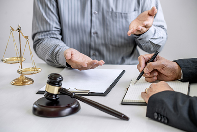 Male Lawyer Or Counselor Working In Courtroom Have Meeting With